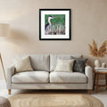 Framed artwork of a heron among reeds on a green background
