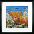 Framed artwork of a highland cow with a mountainous background