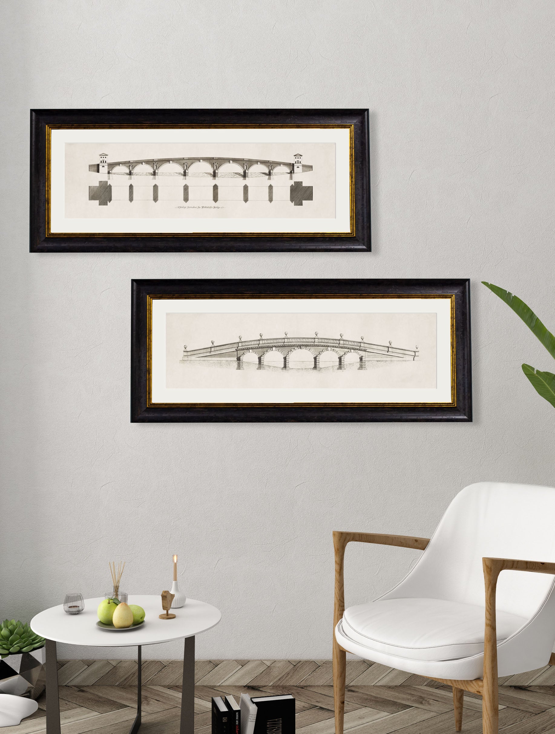 Two framed architectural drawings on a wall above a chair and small table.